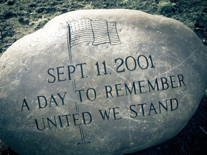 Memorial stone engraved with an American flag and the words "Sept. 11, 2001, A Day to Remember, United We Stand"